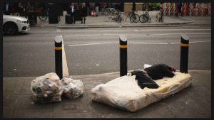 A rough sleeper lays on a mattress as a makeshift bed, in Whitechapel. Photo: DANIEL LEAL/AFP via Getty Images 