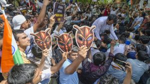 A supporter of India’s satirical Cockroach Janta Party dons a cockroach mask during a protest over alleged exam irregularities in New Delhi. Image: Raj K Raj/Hindustan Times/Getty