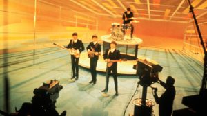 The Beatles perform on The Ed Sullivan Show, 1964. Image: Bettmann/ Getty