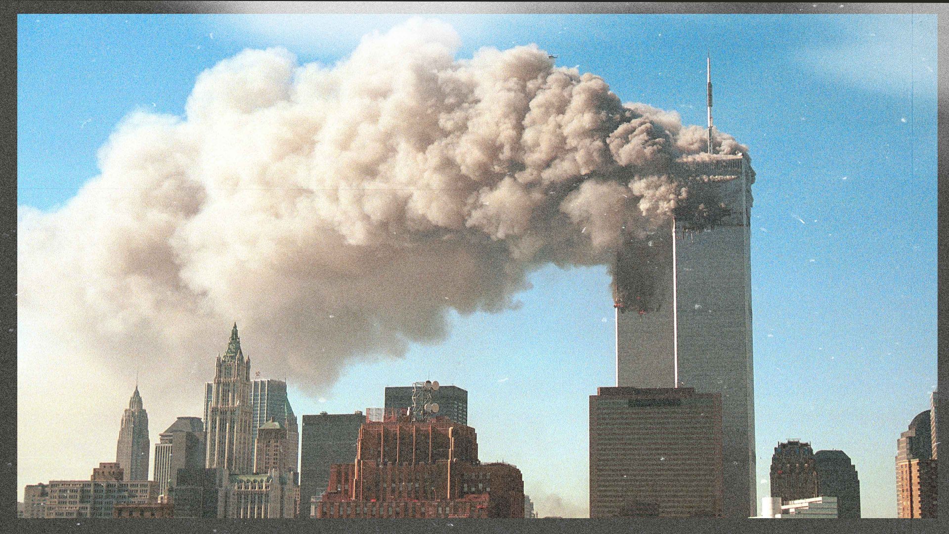 Smoke pours from the World Trade Centre after it was hit by two hijacjked passenger planes September 11, 2001 in New York City in an alleged terrorist attack. Photo: Robert Giroux/Getty Images. Image design: TNW