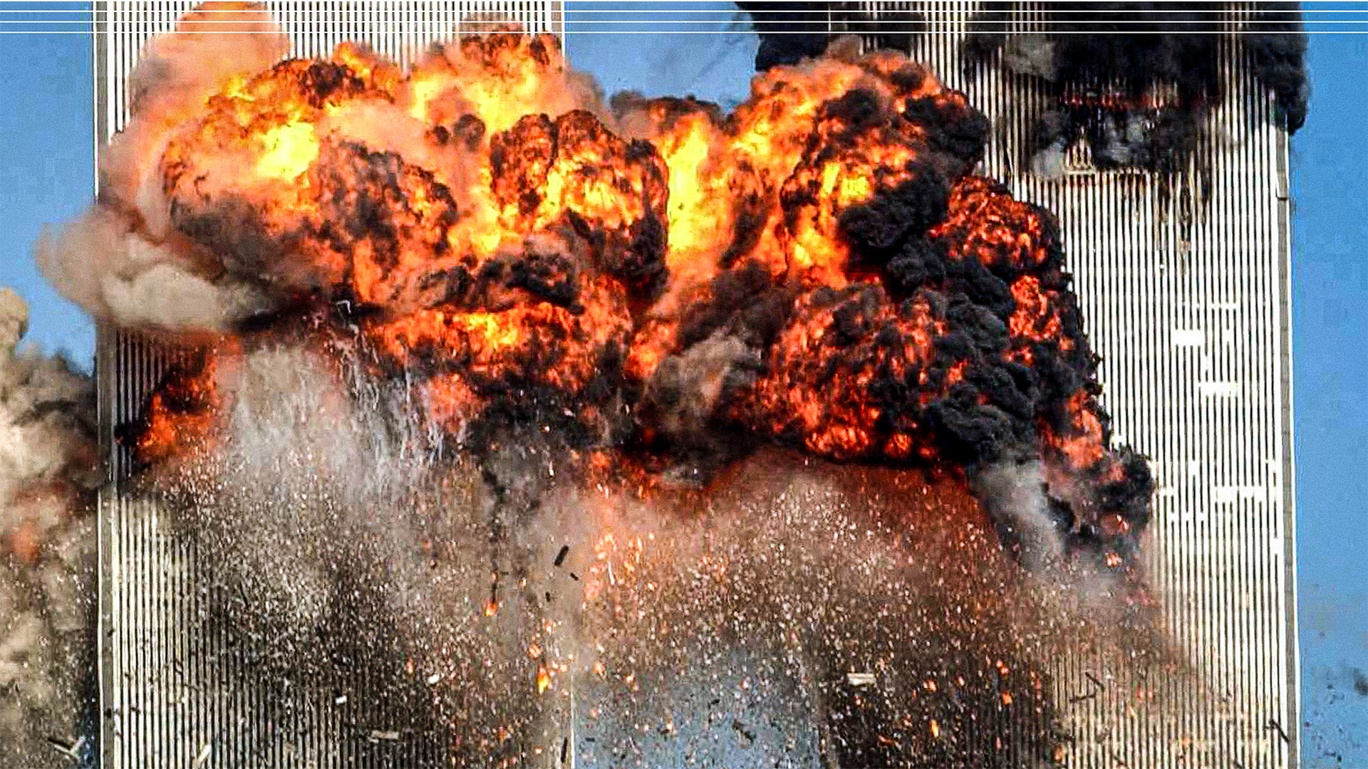 A fiery blasts rocks the south tower of the World Trade Center as the hijacked United Airlines Flight 175 from Boston crashes into the building September 11, 2001. Photo: Spencer Platt/Getty Images. Design: TNW