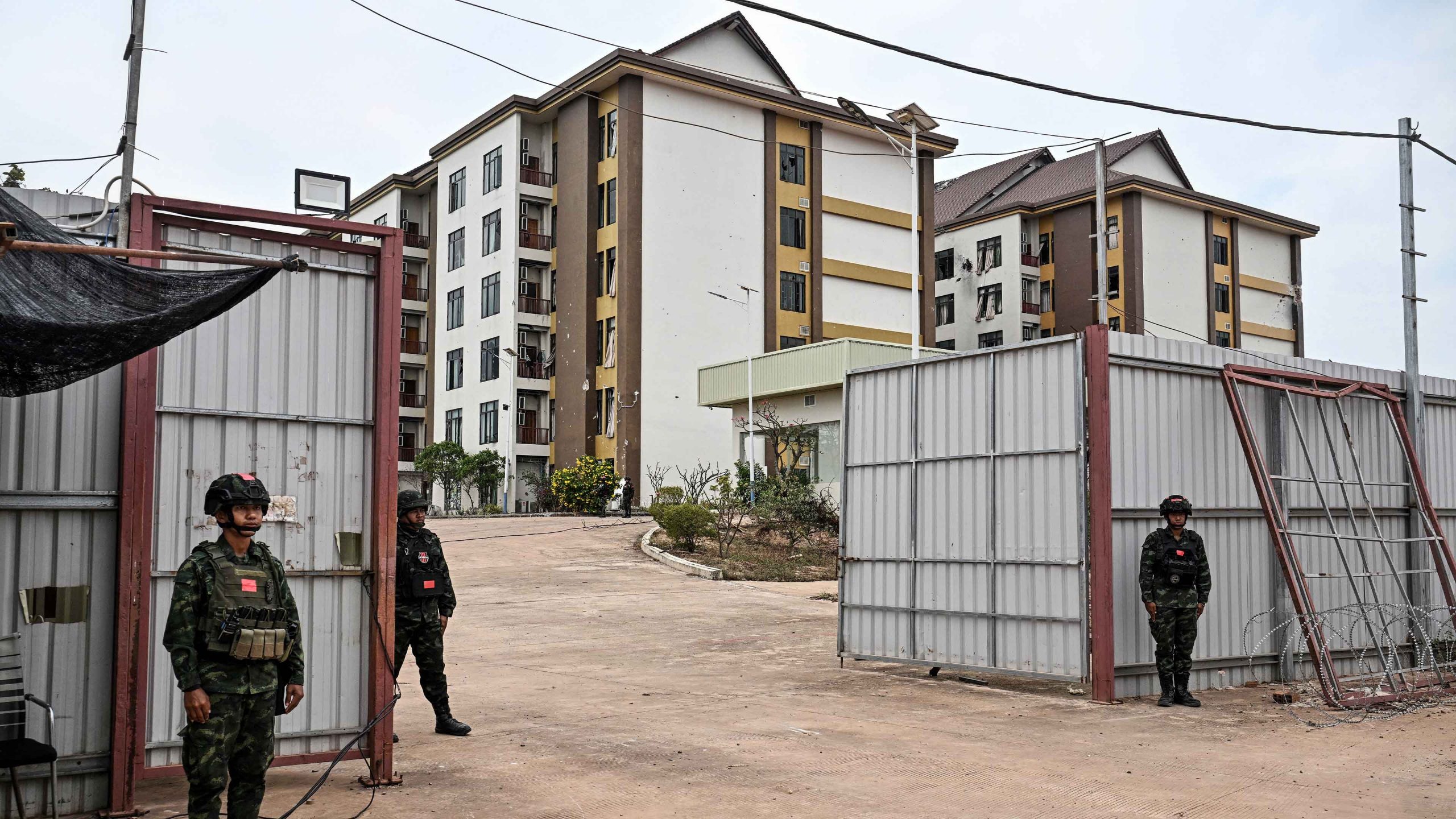 Royal Thai Army soldiers stand outside an abandoned scam centre in O'Smach town on the Thai-Cambodian border. Photo: Lillian SUWANRUMPHA / AFP via Getty Images